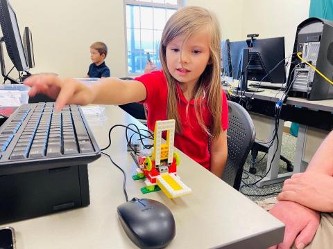 Image of child testing out LEGO Robotics