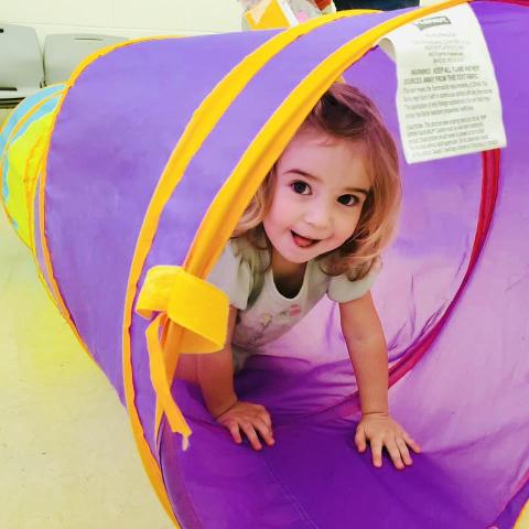 Image of child crawling through tunnel