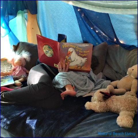 Image of kid reading in a fort