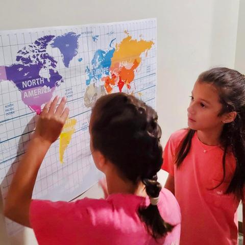 Image of girls studying map in escape room