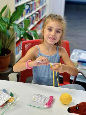 Image of child crocheting