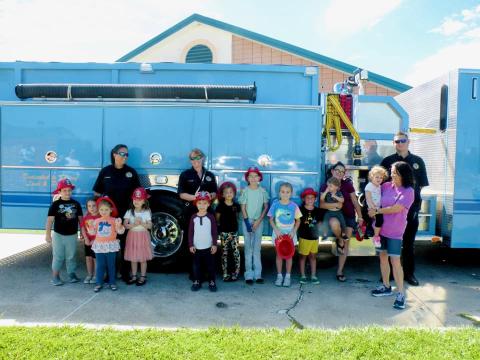 Image of kids in front of fire truck