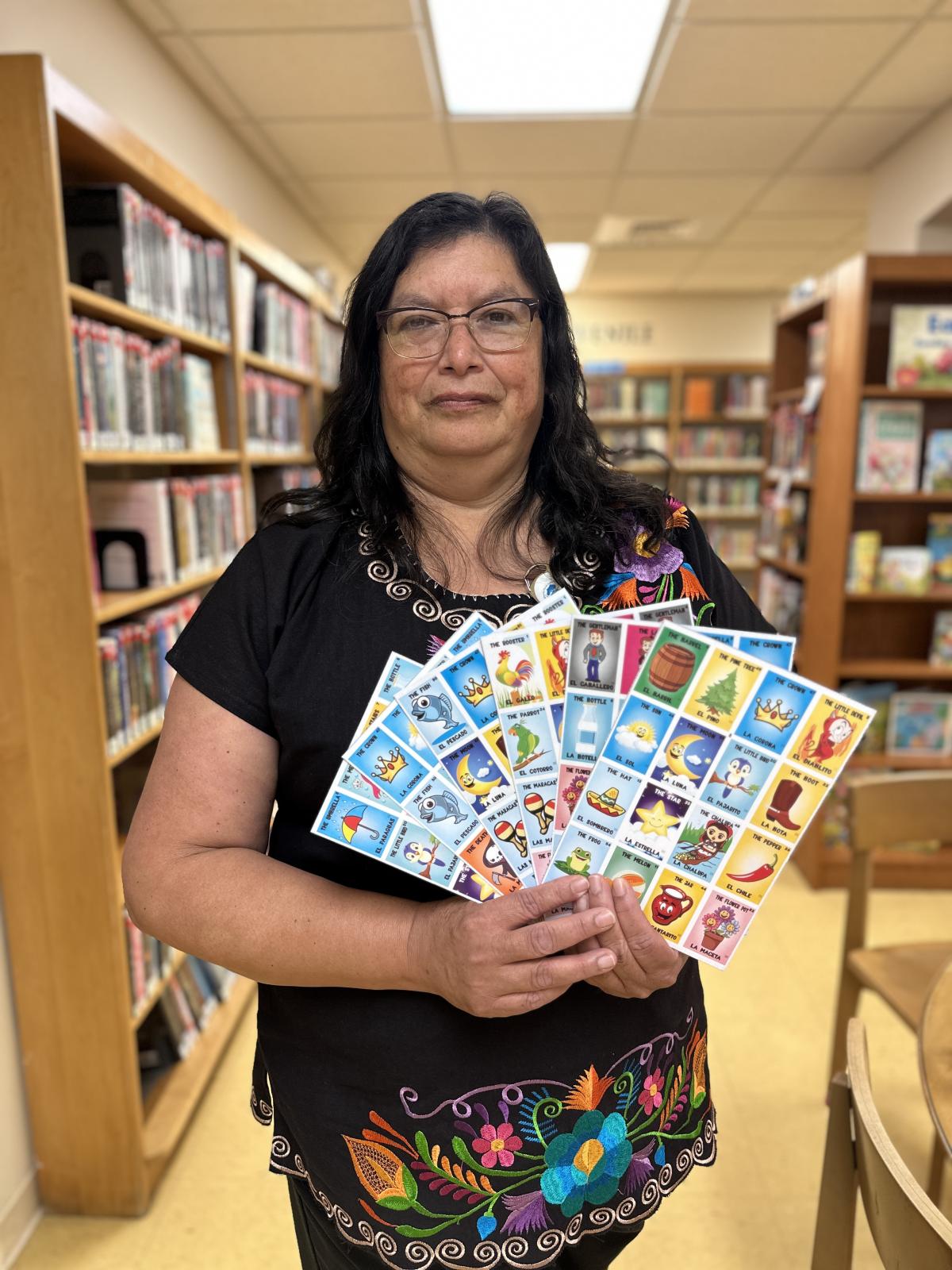 Image of woman holding bilingual bingo cards