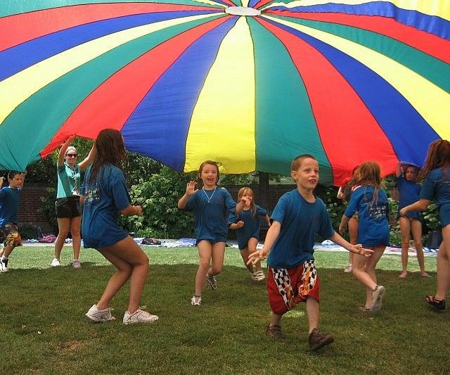 Image of kids playing with giant parachute