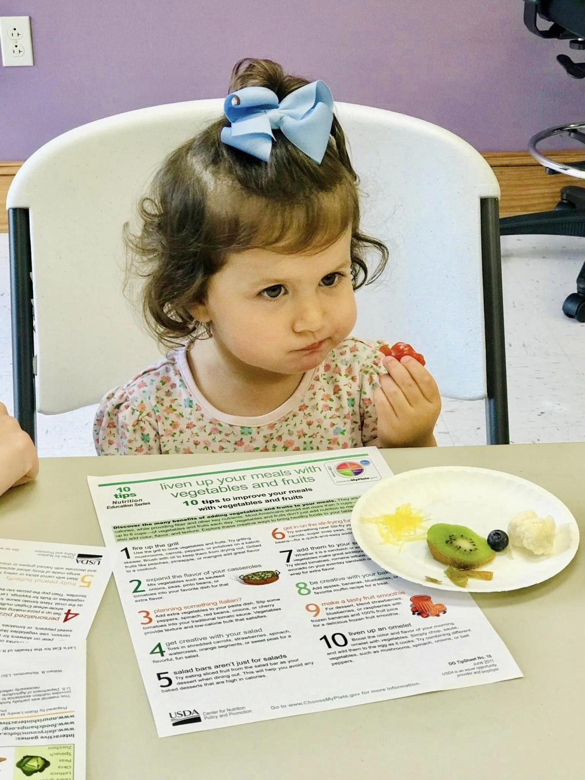 Image of child eating fruit