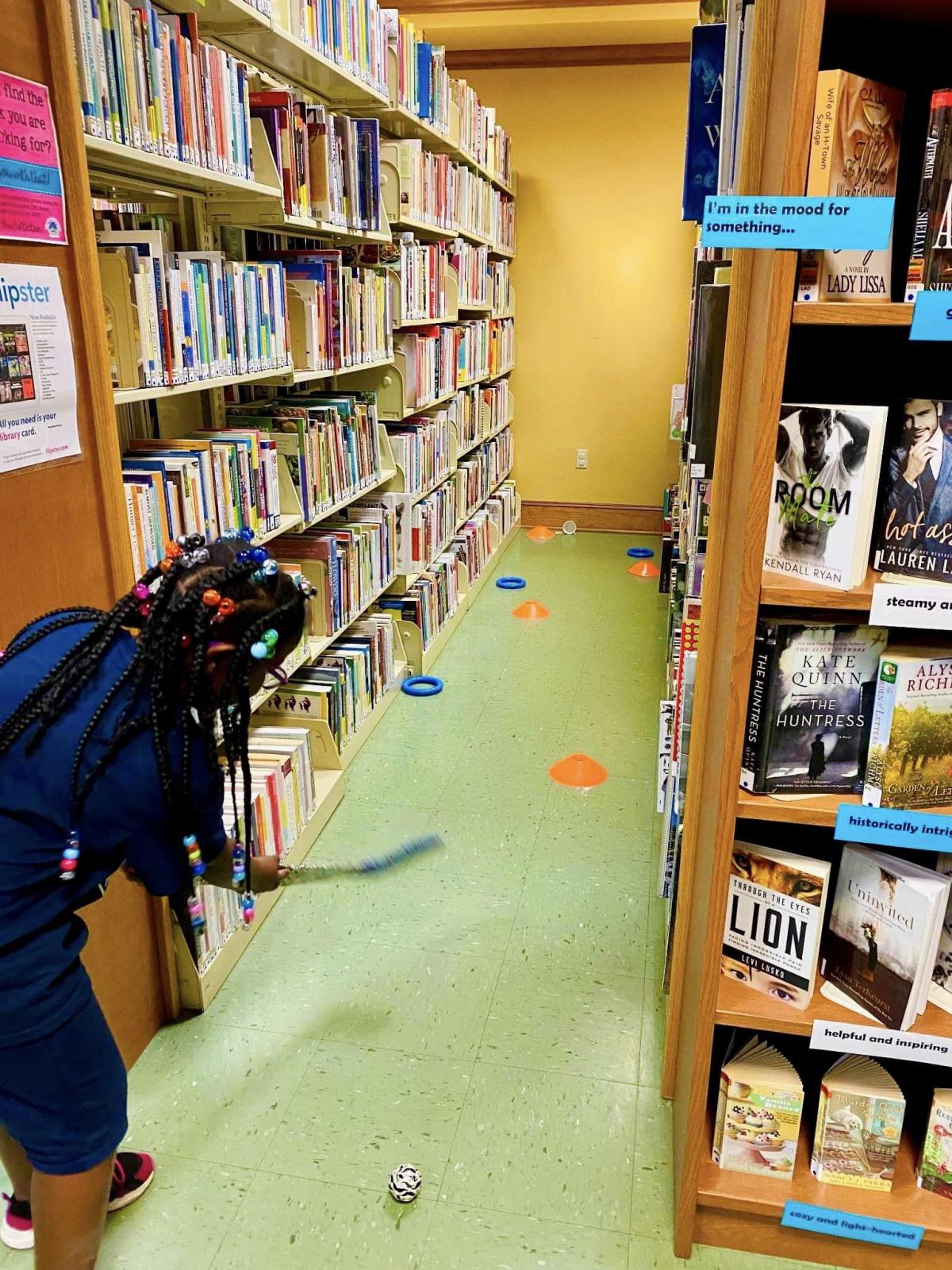 Image of person playing mini golf in the stacks