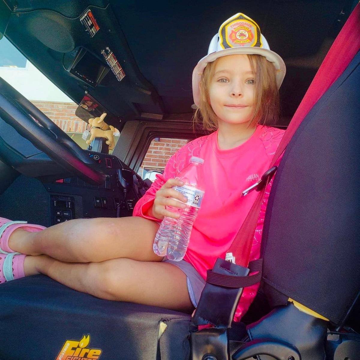 Image of child sitting in fire truck