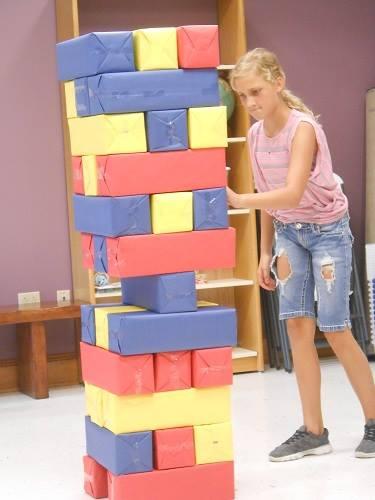 Image of kid playing giant Jenga