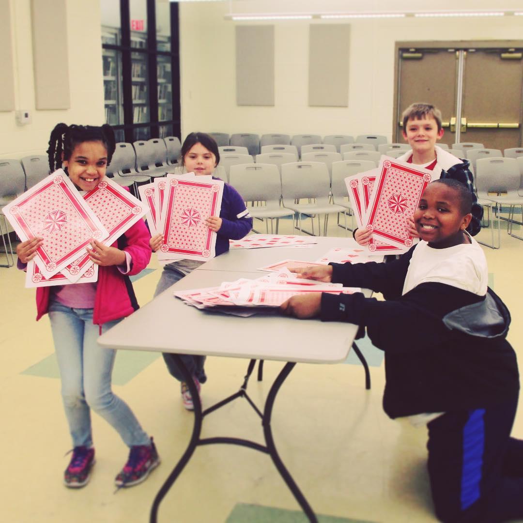 Image of kids with jumbo playing cards